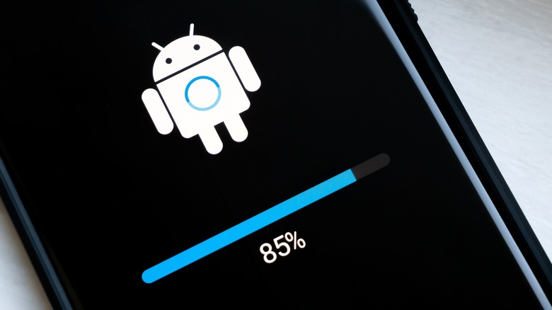 Keep Android Software Updated – UpgradeByUs An Android smartphone screen displaying a system update progress bar at 85 percent with the Android mascot